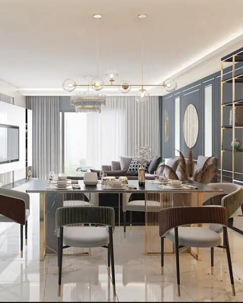 Akasya Koru Evleri salon ve yemek alanında metal ayaklı masa, raf sistemi ve mermer TV duvarı