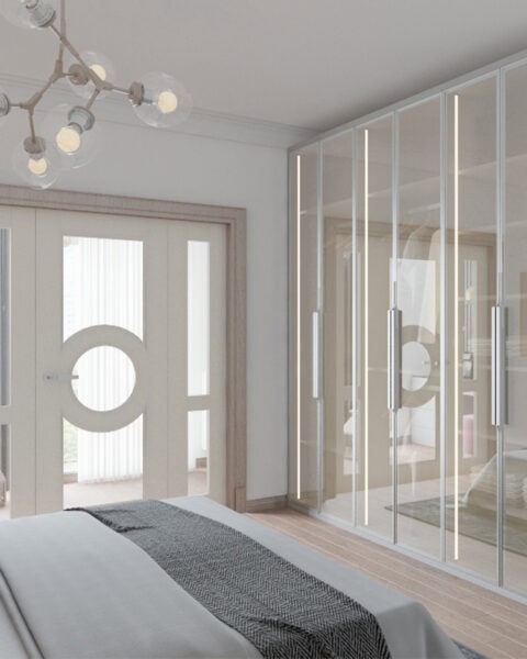 Modern bedroom with a glass-front wardrobe along the right and a double door with a circular window detail.