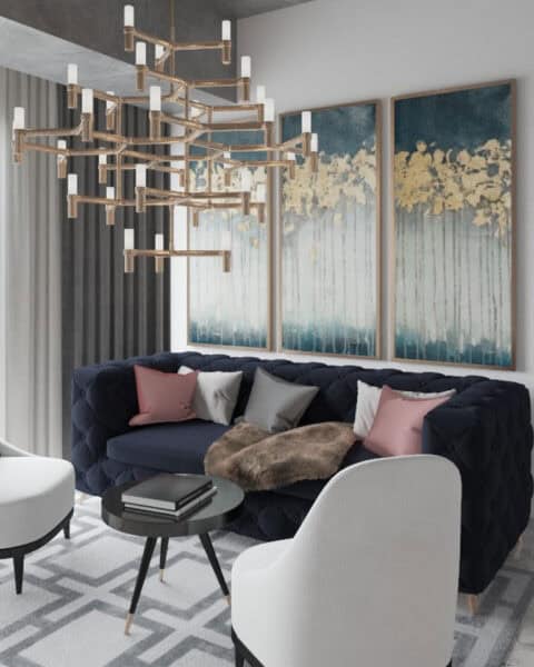 Bomonti salon tasarımında lacivert koltuk, beyaz berjer ve büyük avize detayı