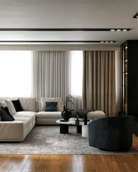 Caddebostan salon oturma alanı - tuğ mimarlık Caddebostan salonunda geniş koltuk, siyah berjer ve tv duvarıyla modern oturma alanı tasarımı