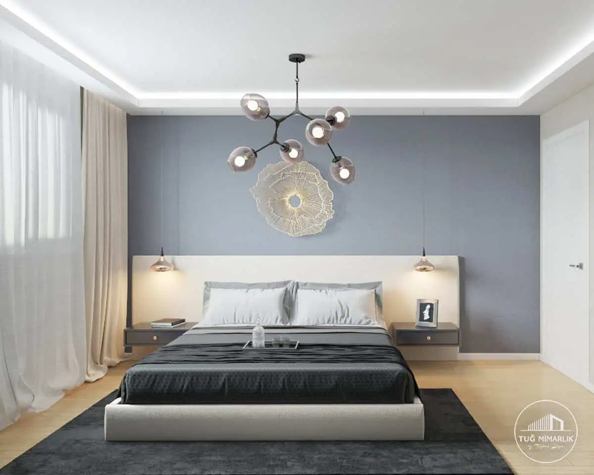 Suadiye yatak odası başucu aydınlatma - tuğ mimarlık Suadiye yatak odasında başucu sarkıt aydınlatma, geniş yatak yerleşimi ve gri duvarla modern tasarım